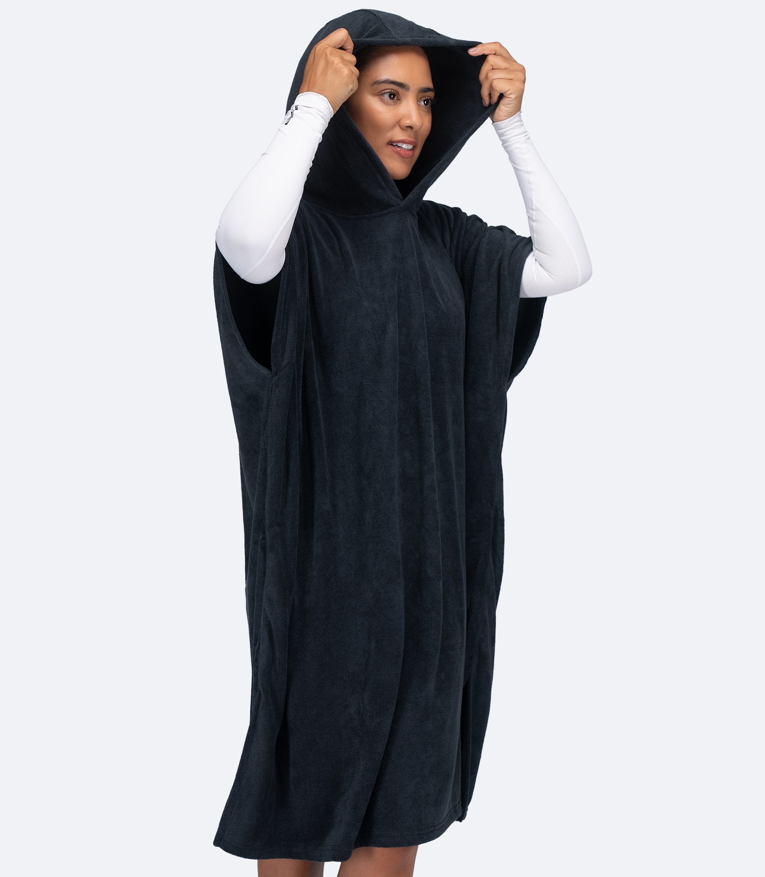 Zhik Hooded Towel in Dark Blue on female model, featuring roomy front pocket and lightweight towelling material.