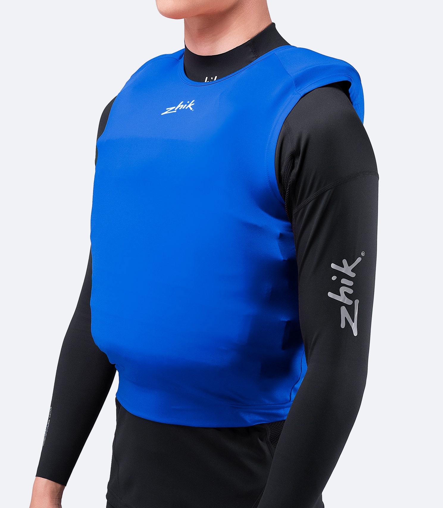 Side view of Zhik Spandex Event Pinnie in Cyan, highlighting stretch fabric, breathable comfort, and ergonomic seam placement.