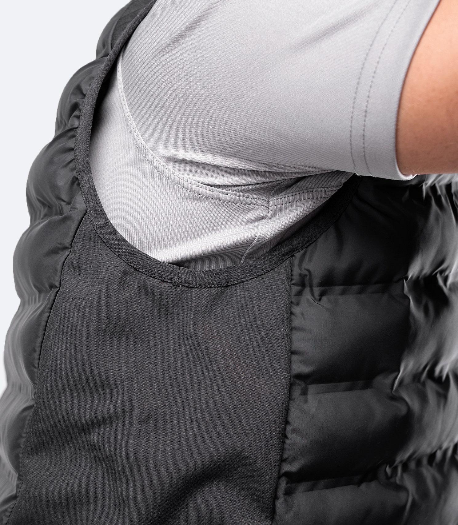 Close-up under-shoulder side view of Black Cell Vest – ergonomic cut for freedom of movement.