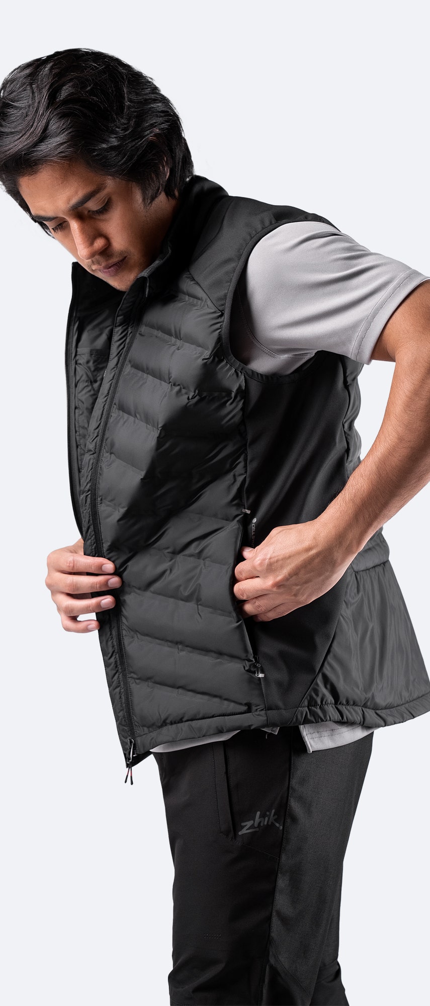 Men’s Black Cell Insulated Vest side view – technical design with reflective detailing and zippered utility pockets.