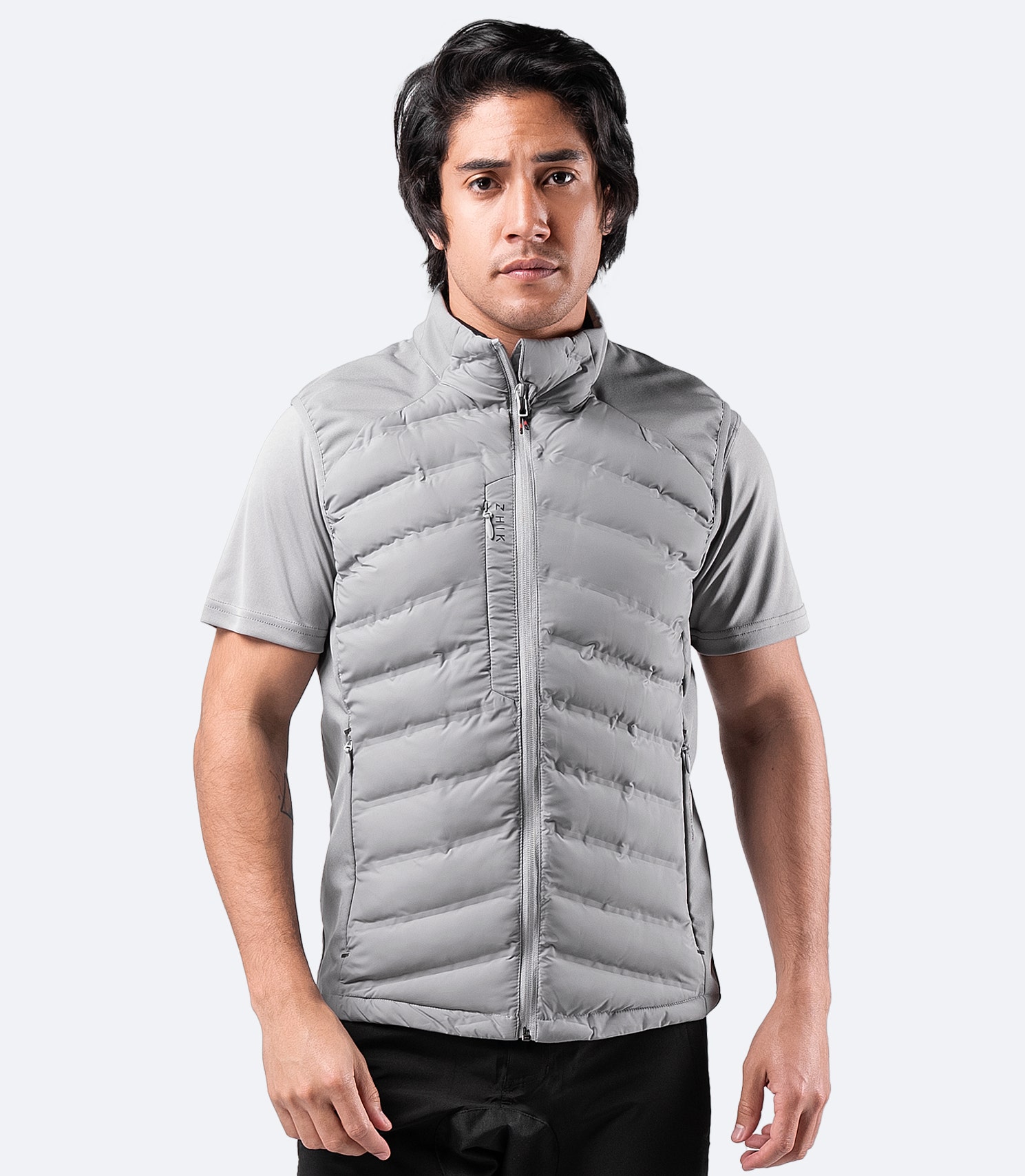 Men’s Platinum Cell Insulated Vest worn casually – stylish mid-layer with fleece-lined collar and pockets for warmth and comfort.
