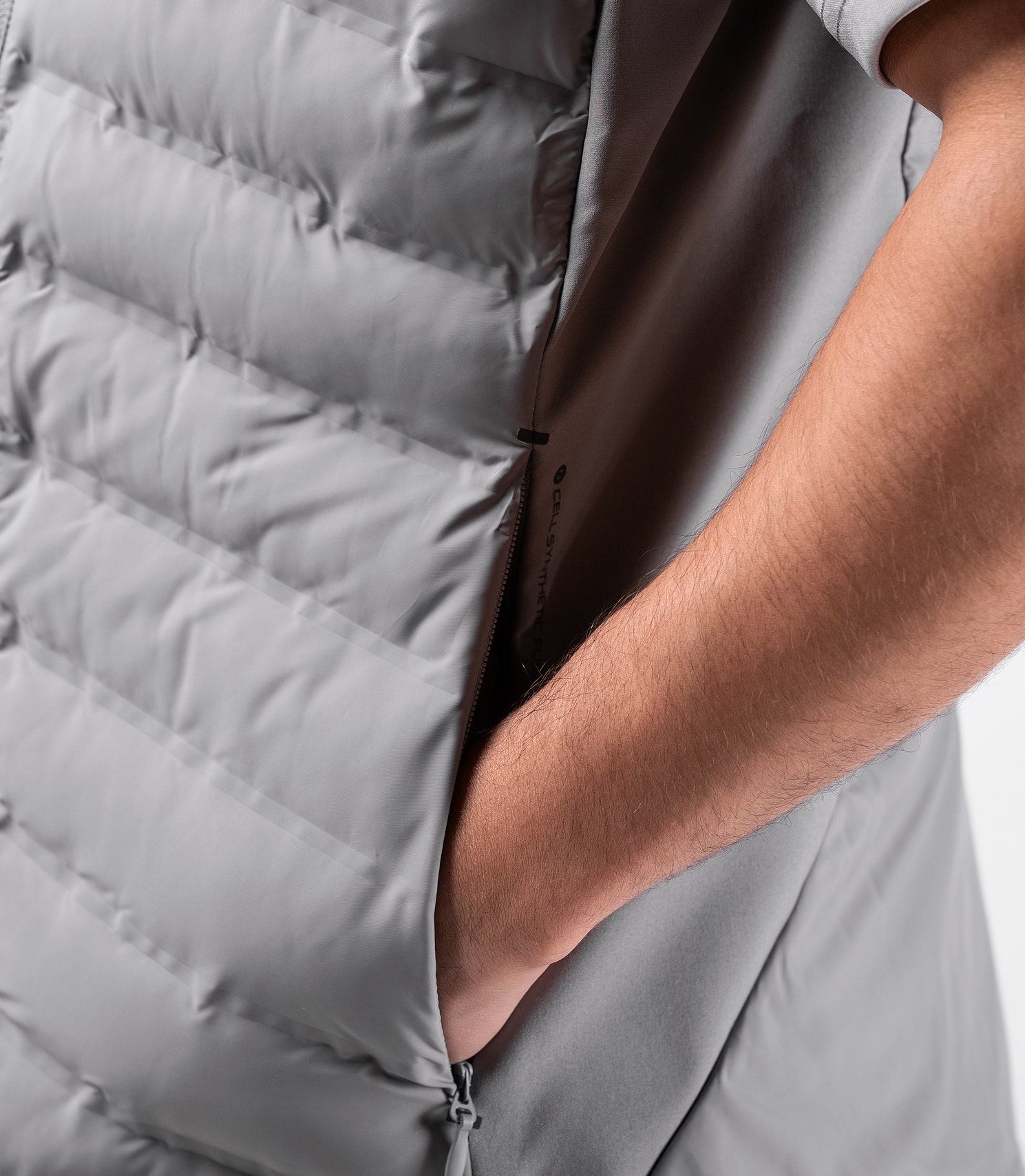 Close-up of Platinum Cell Vest side zipper pocket – secure storage for essentials with technical styling.