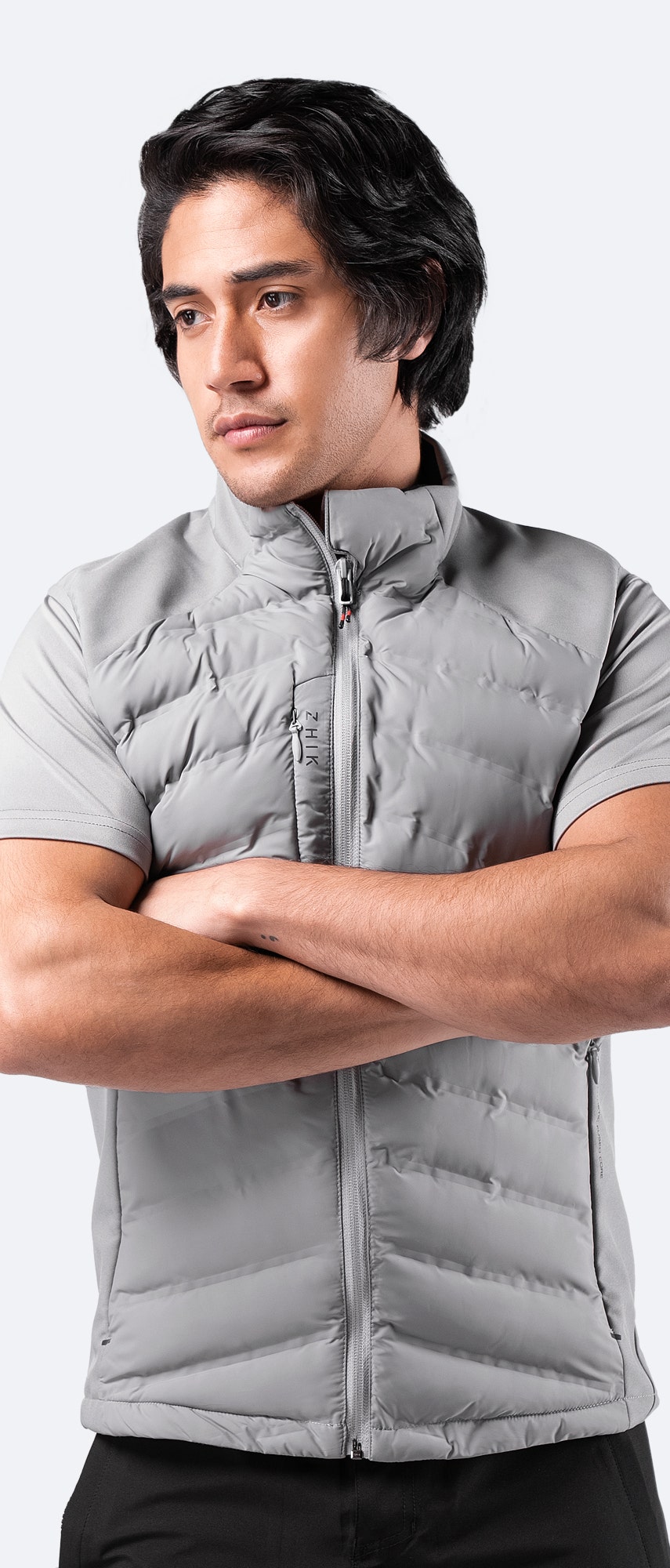 Men’s Platinum Cell Insulated Vest worn casually – stylish mid-layer with fleece-lined collar and pockets for warmth and comfort.