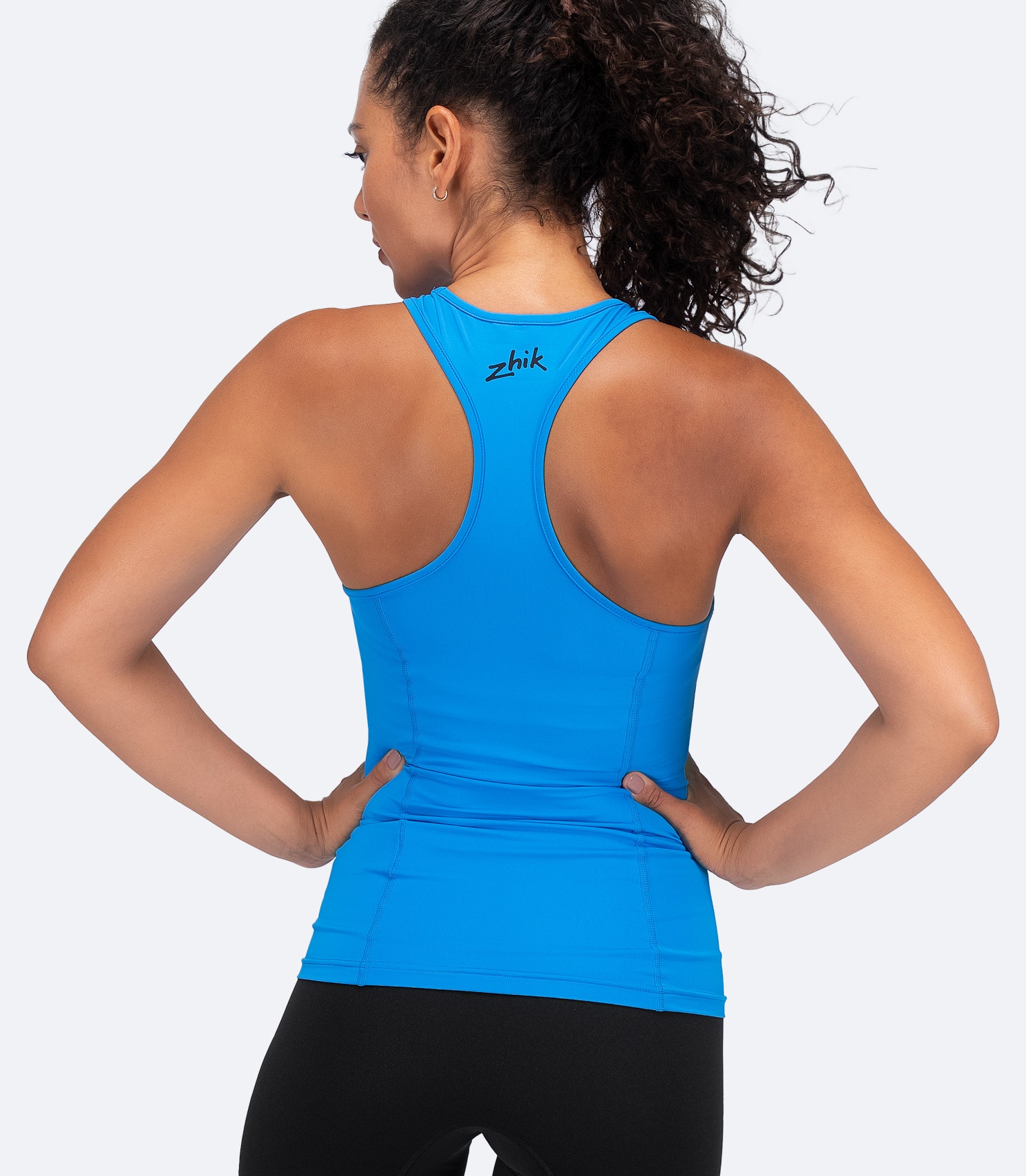 Back view of Zhik Women's Eco Spandex LT Race Singlet in Cyan with racerback cut and flatlock seams for anti-rash comfort.