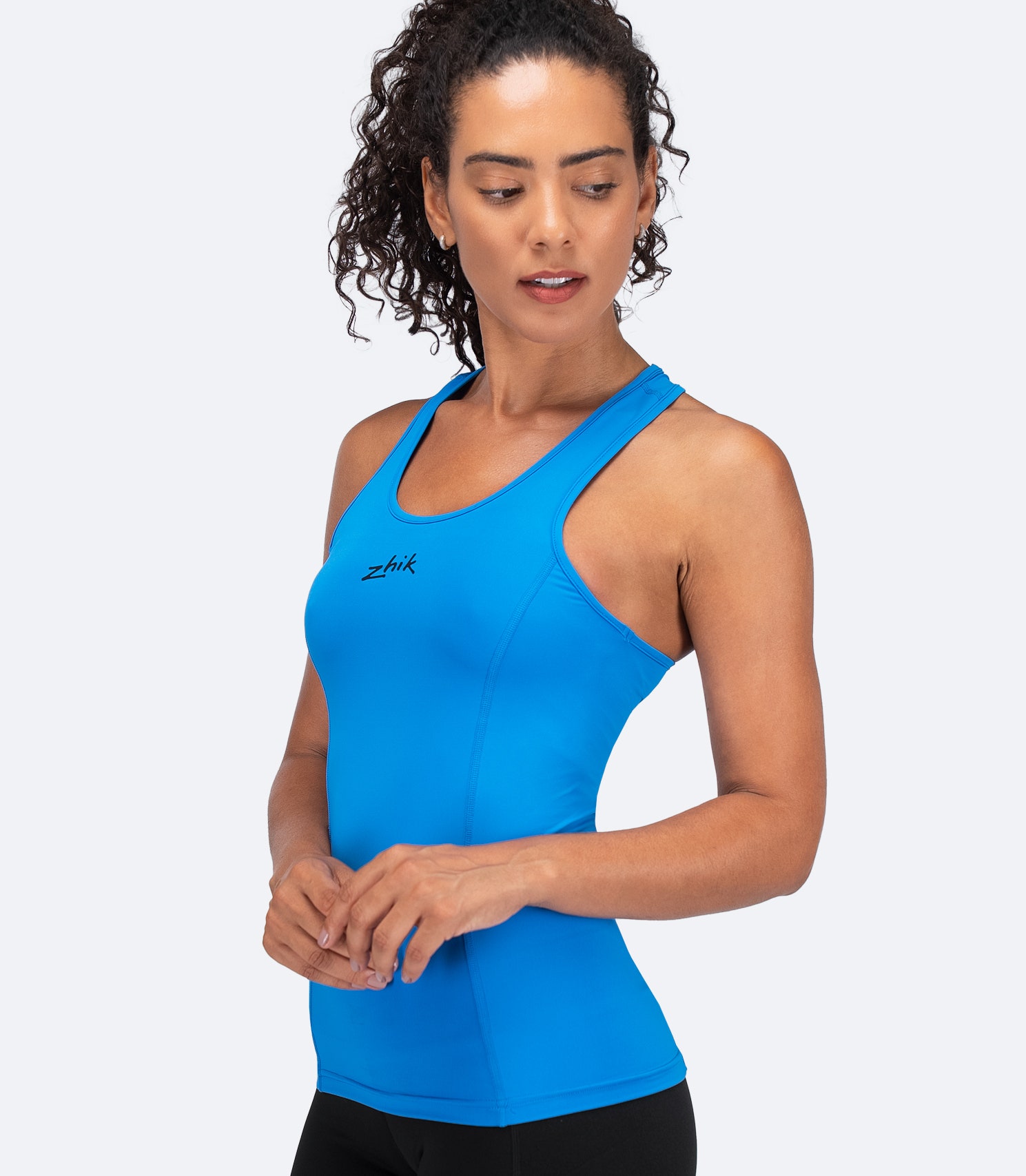 Side profile of Zhik Women's Eco Spandex LT Race Singlet in Cyan showing 4-way stretch and UPF 50+ sun protection.