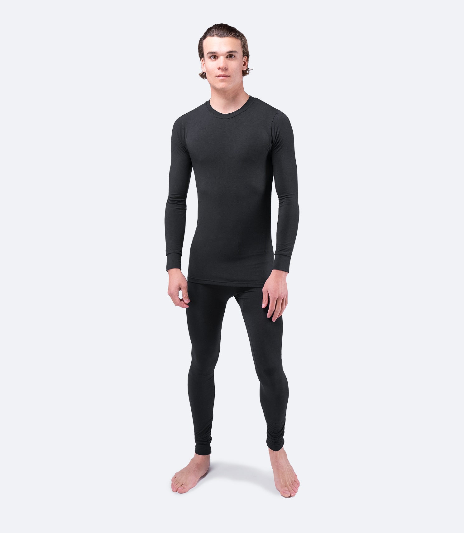 Unisex Zhik Core Baselayer Top in black, front view, figure-fitting with lightweight insulation.
