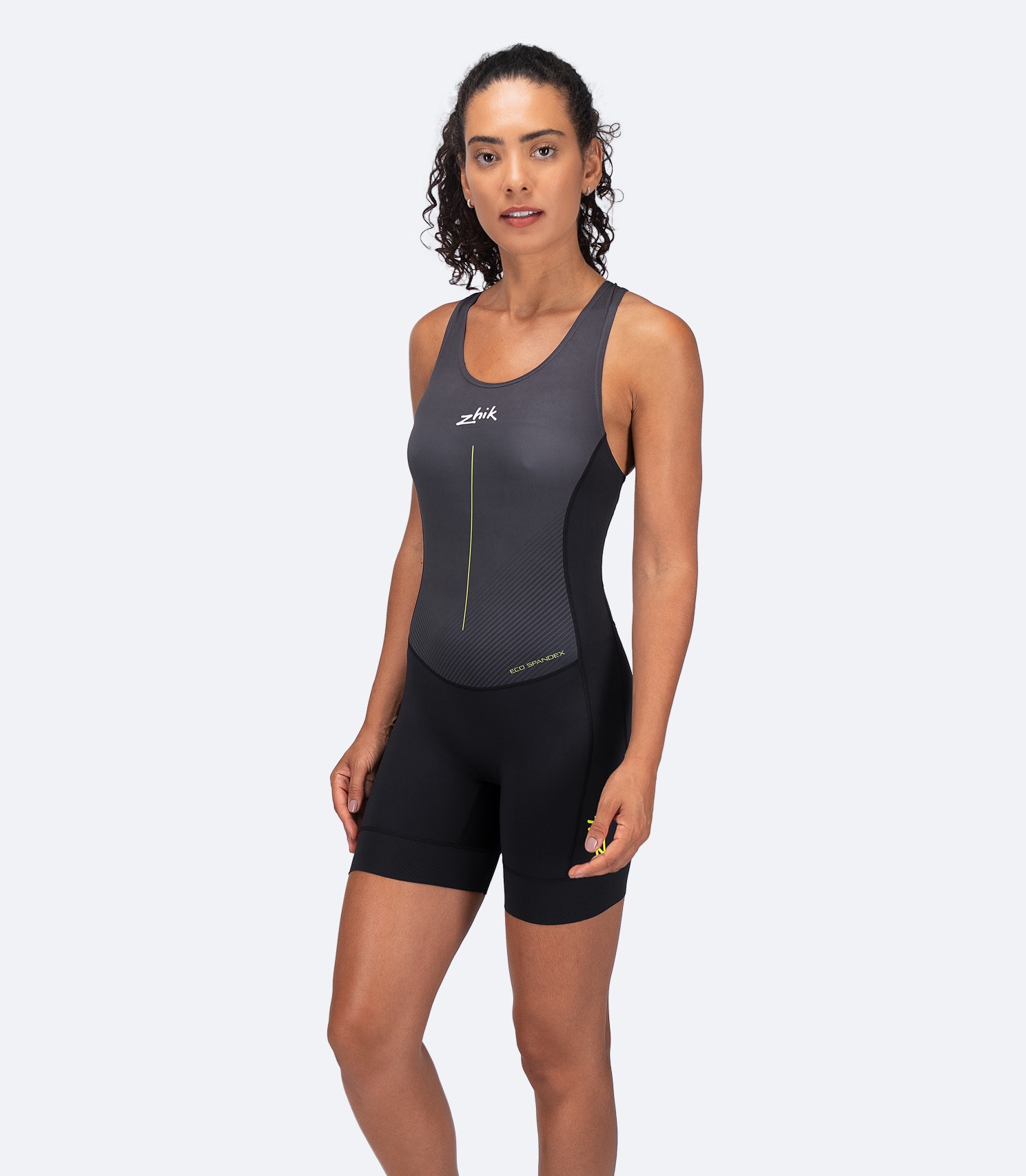 Female athlete wearing Zhik Women's Performance Unisuit in black, with high-stretch, fast-drying fabric for unrestricted movement.