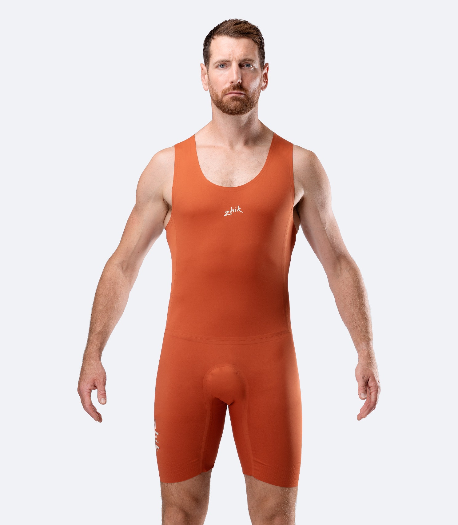 Zhik Men’s X Unisuit in Red Earth front view with fused seams and graphene-infused stretch fabric.