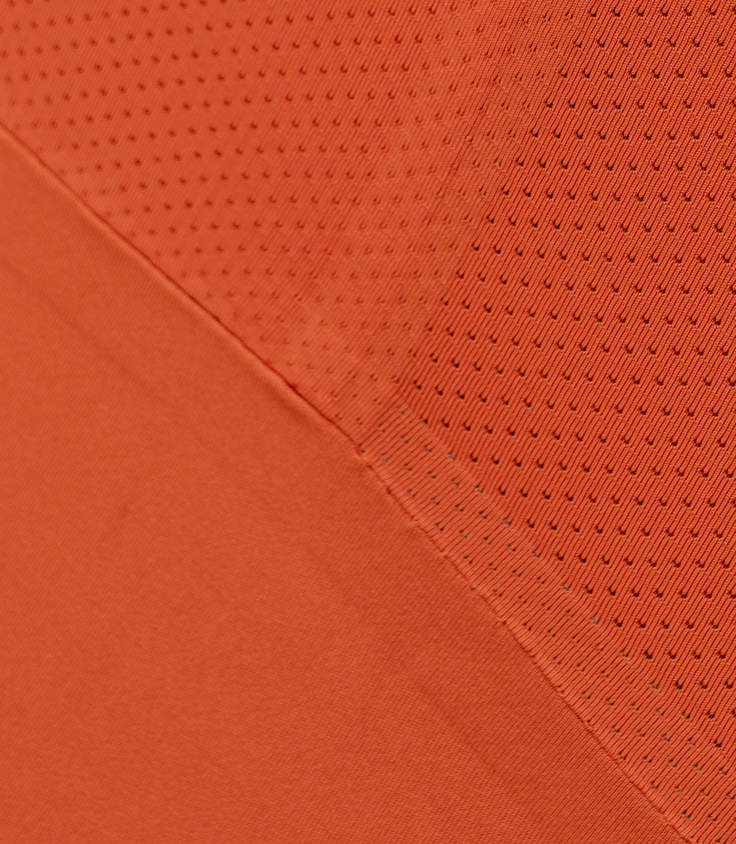 Close-up of Zhik Women's X Unisuit in Red Earth showing breathable mesh panel and stitch-free fused seams.