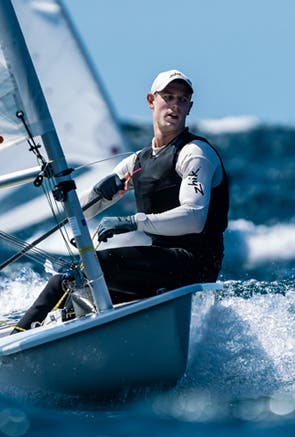Man in dinghy with Zhik tops