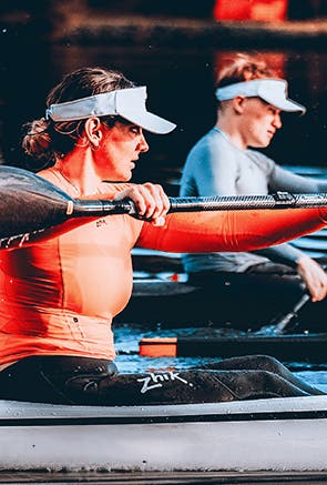 Man paddling with Zhik tops