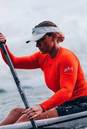 Man paddling with Zhik tops